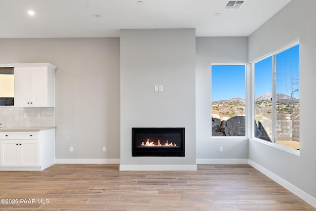 unfurnished living room featuring light hardwood / wood-style flooring