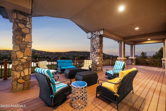 deck at dusk featuring an outdoor living space