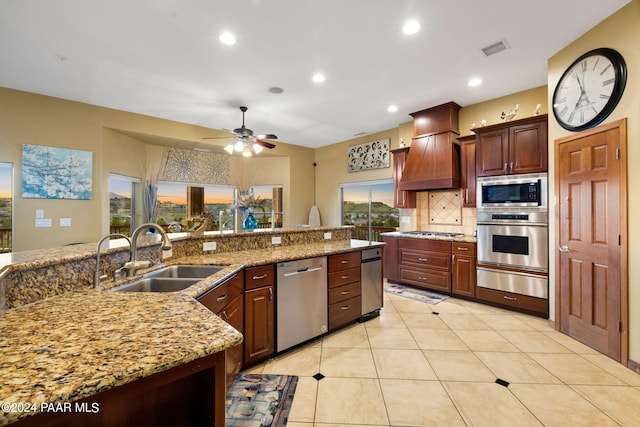 kitchen featuring custom range hood, stainless steel appliances, ceiling fan, sink, and light tile patterned flooring