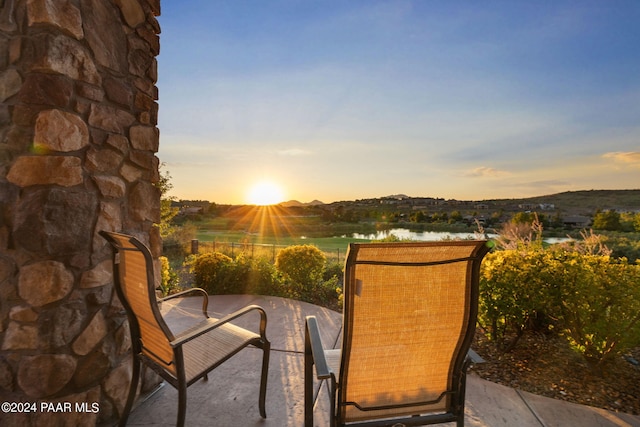 patio terrace at dusk with a water view