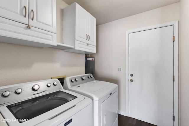 laundry area with cabinets, dark hardwood / wood-style floors, and washer and clothes dryer