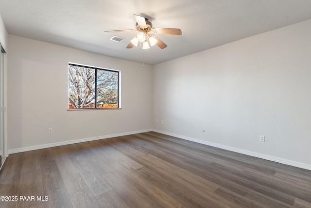 unfurnished room featuring dark hardwood / wood-style floors and ceiling fan