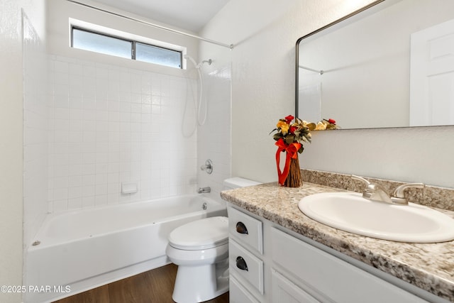 full bathroom featuring vanity, hardwood / wood-style flooring, toilet, and tub / shower combination