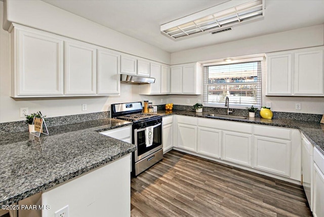 kitchen featuring white cabinetry, sink, dark wood-type flooring, dark stone counters, and stainless steel range with gas cooktop