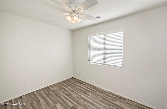 unfurnished room with ceiling fan and dark hardwood / wood-style floors