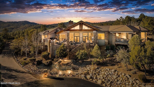 back house at dusk with a mountain view