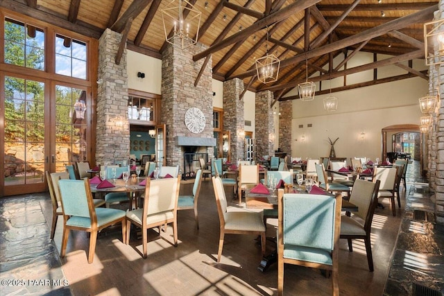 dining room featuring beamed ceiling, wood ceiling, a fireplace, and high vaulted ceiling