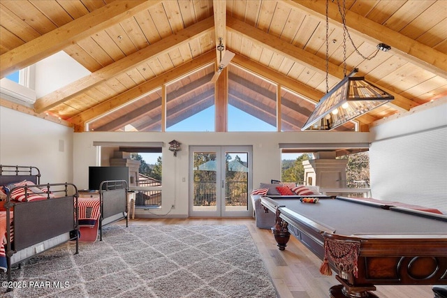 rec room featuring beamed ceiling, french doors, and hardwood / wood-style flooring