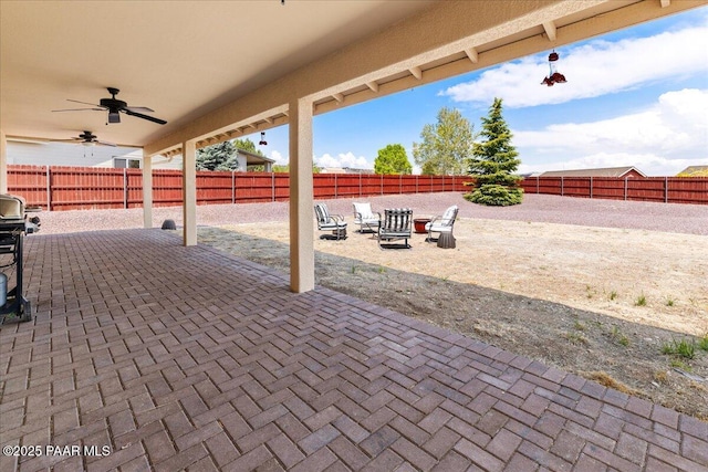 view of patio with a fenced backyard and ceiling fan