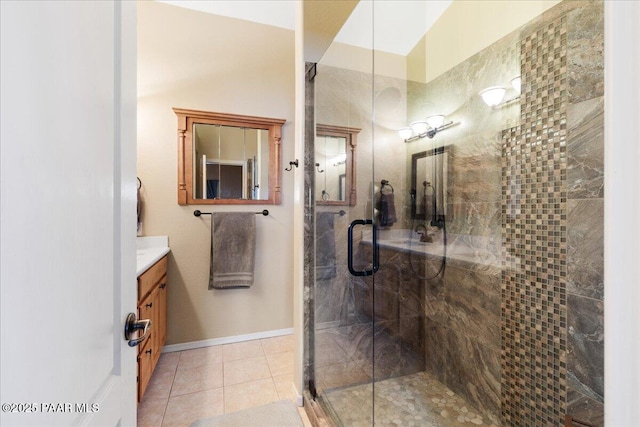 bathroom featuring vanity, a shower stall, and tile patterned flooring
