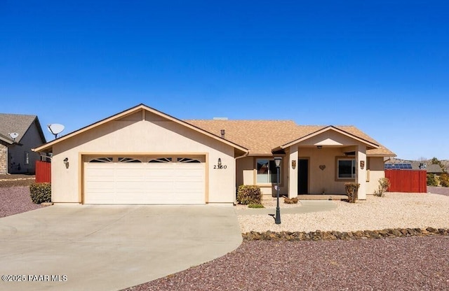ranch-style house with stucco siding, driveway, and a garage