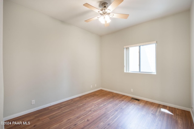 empty room with wood-type flooring and ceiling fan