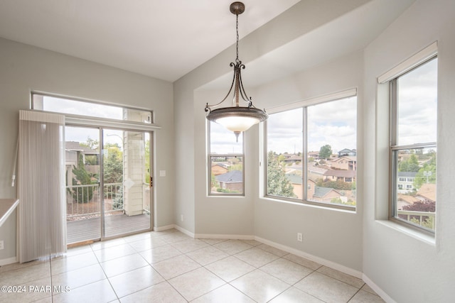 unfurnished dining area with light tile patterned floors