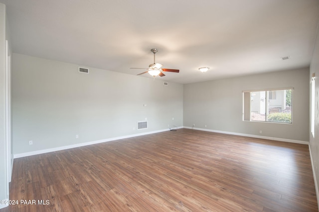 empty room featuring ceiling fan and dark hardwood / wood-style floors