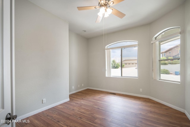 spare room with ceiling fan and dark wood-type flooring