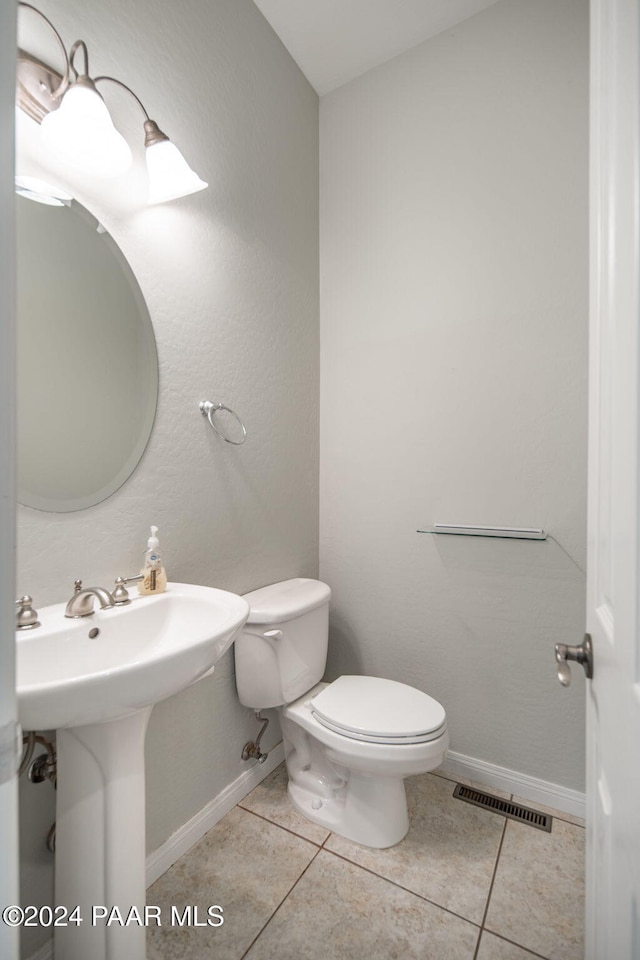 bathroom featuring tile patterned floors and toilet