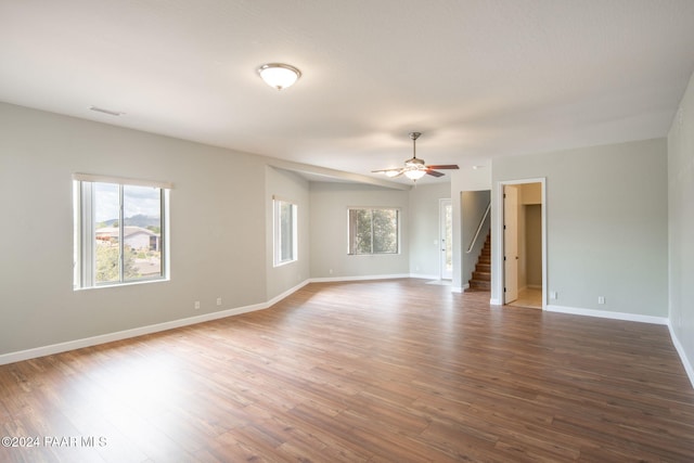 spare room with hardwood / wood-style flooring, ceiling fan, and a healthy amount of sunlight