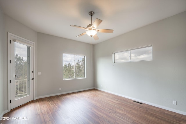 empty room featuring ceiling fan and hardwood / wood-style flooring