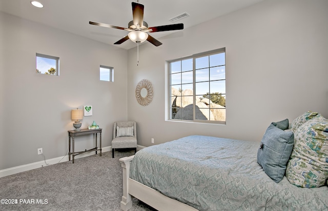 bedroom featuring multiple windows, ceiling fan, and carpet