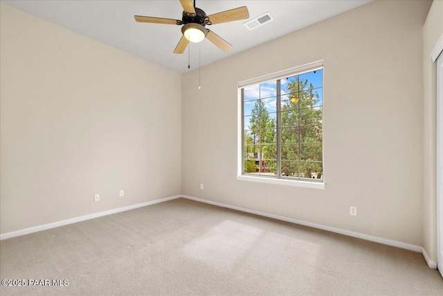 unfurnished room featuring a ceiling fan, baseboards, visible vents, and light carpet