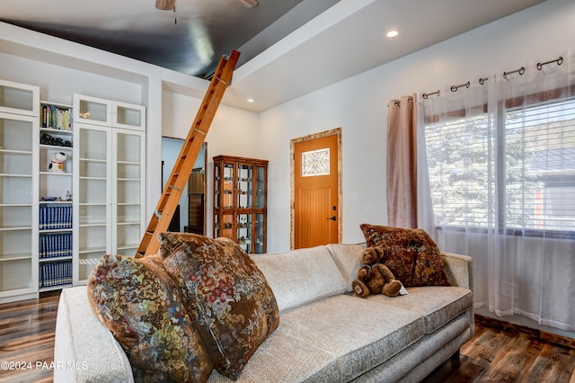 living room with ceiling fan and dark hardwood / wood-style flooring