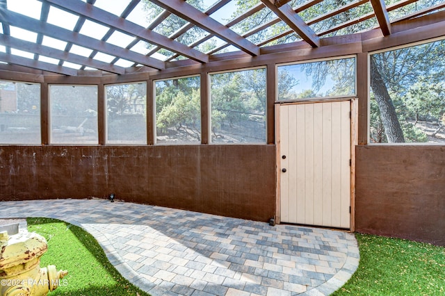 unfurnished sunroom featuring vaulted ceiling