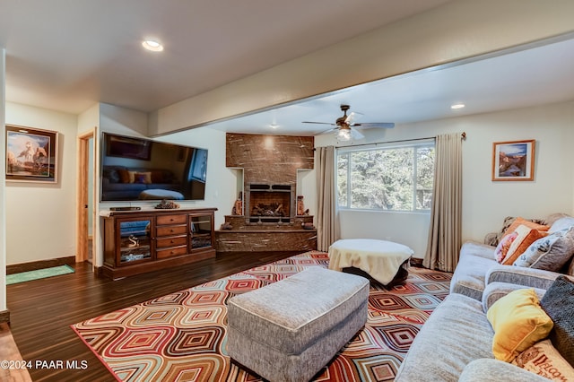 living room with a fireplace, hardwood / wood-style flooring, and ceiling fan