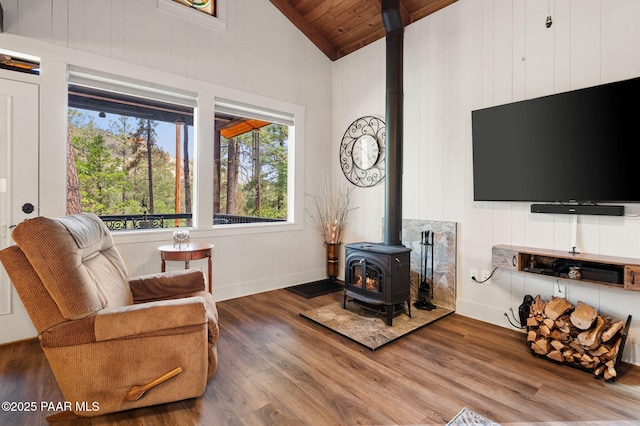 6231 S Champion Way Rd, Prescott, AZ 86303 - living area featuring a wood stove, a wood ceiling with exposed beams, wood finished floors, high vaulted ceiling, and wood walls