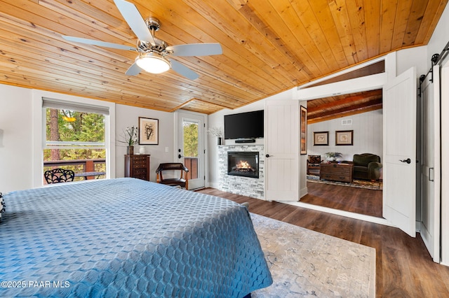 6231 S Champion Way Rd, Prescott, AZ 86303 - bedroom with lofted ceiling, wooden ceiling, multiple windows, wood finished floors, and a glass covered fireplace