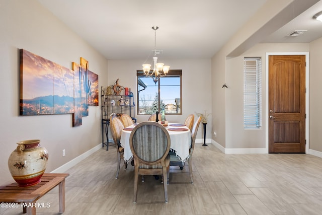 dining area with a chandelier, visible vents, and baseboards