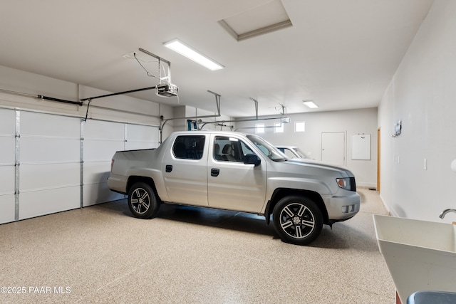 garage featuring a sink and a garage door opener