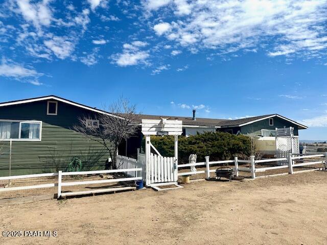 view of front of home featuring fence