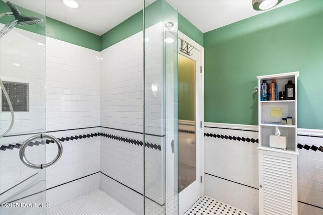 1614 SW Palmcroft Dr, Phoenix, AZ 85007 - bathroom with a shower stall, tile walls, and wainscoting