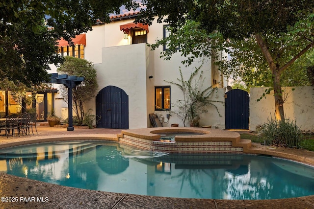 1614 SW Palmcroft Dr, Phoenix, AZ 85007 - rear view of house featuring a gate, a patio area, a pool with connected hot tub, and stucco siding