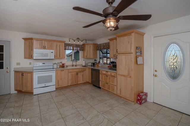 kitchen featuring a healthy amount of sunlight, white appliances, sink, and light brown cabinets