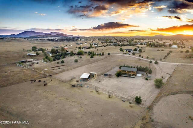 aerial view at dusk featuring a mountain view