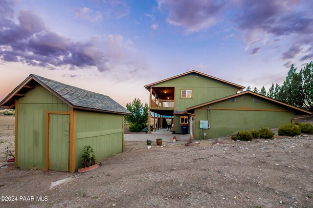 view of front of property with a storage shed