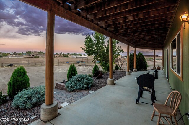 view of patio terrace at dusk