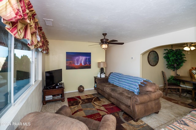 living room featuring ceiling fan and light tile patterned floors