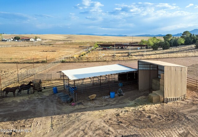 view of stable with a mountain view and a rural view