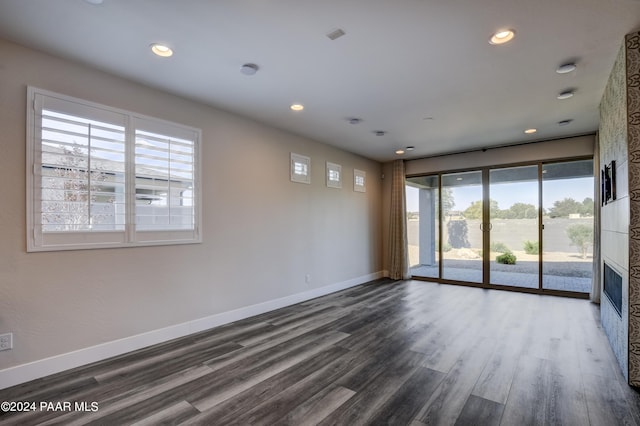 spare room with dark wood-type flooring