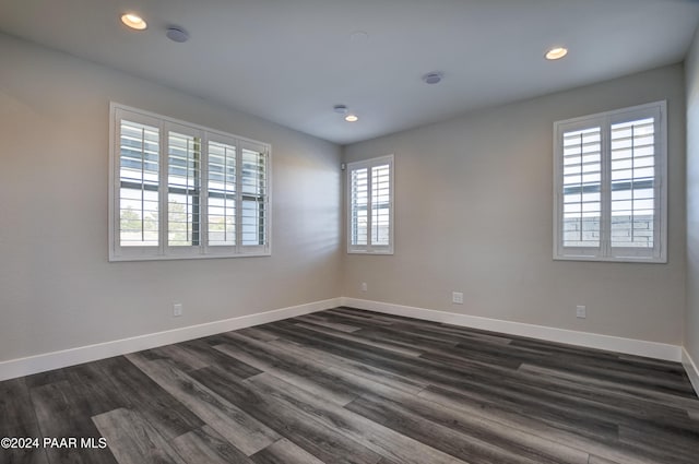 empty room featuring dark hardwood / wood-style floors and plenty of natural light