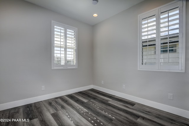 unfurnished room with a wealth of natural light and dark hardwood / wood-style floors