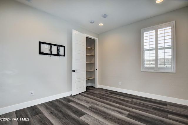 unfurnished room featuring dark hardwood / wood-style flooring