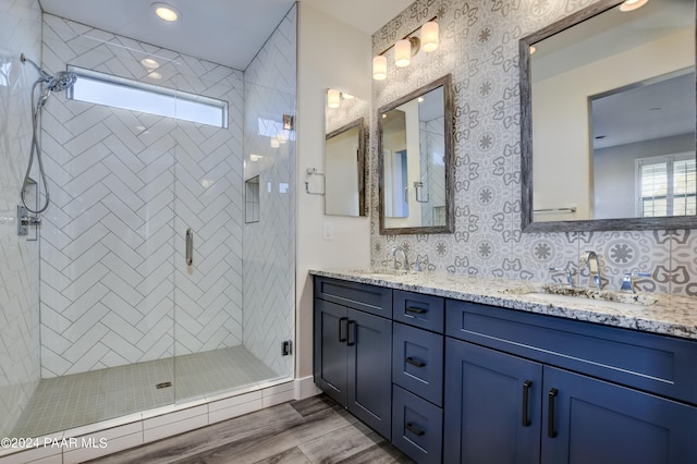 bathroom featuring vanity, backsplash, and walk in shower