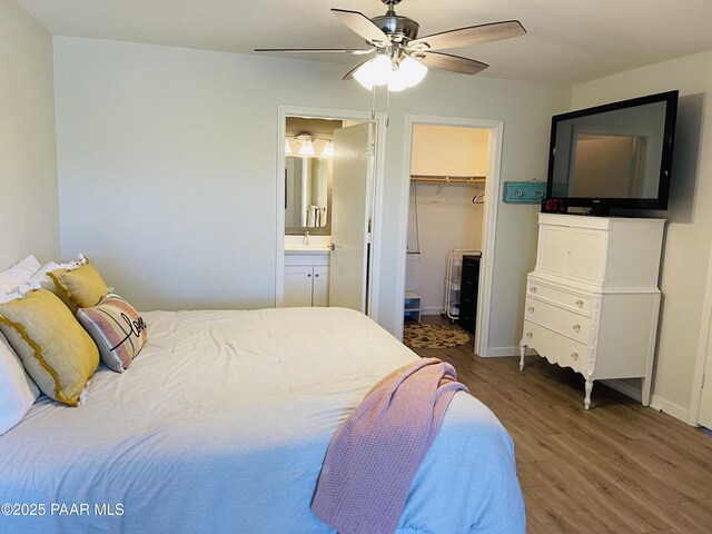 3070 Smokey Rd Unit 17E, Prescott, AZ 86301 - bedroom with wood finished floors, a spacious closet, a closet, connected bathroom, and a ceiling fan