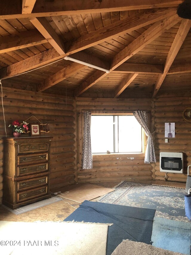 interior space with beamed ceiling, wooden ceiling, rustic walls, and heating unit