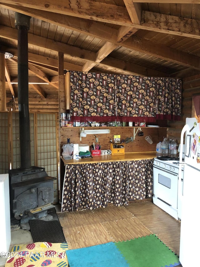 wine cellar featuring beamed ceiling, wood-type flooring, a wood stove, and wood ceiling