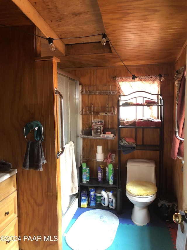 bathroom featuring wooden walls, vanity, wood ceiling, and an enclosed shower