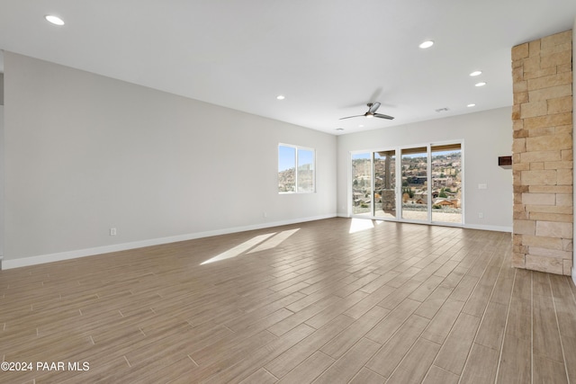 unfurnished room featuring ceiling fan and light hardwood / wood-style floors